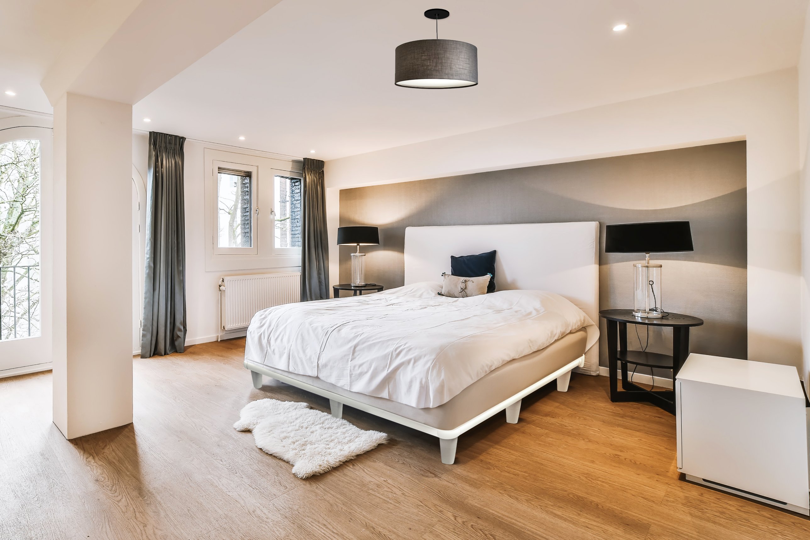 Bedroom with an emBrace 360 in Pure White under an upholstered headboard